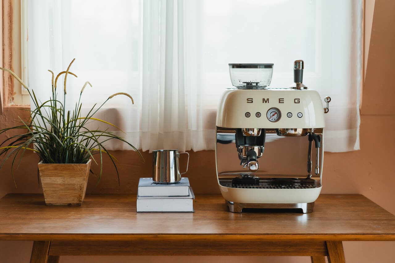 Smeg EGF03 espresso machine on a kitchen counter alongside matching Smeg appliances